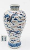 A Chinese underglaze blue and copper-red meiping vase: painted with five dragons amongst cloud and