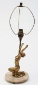 An Art Deco period table lamp: decorated with a kneeling figure of a woman wearing vest and skirt,
