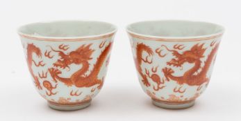 A pair of Chinese porcelain wine cups: of thinly potted form the exterior of each painted in copper