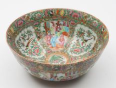 A Canton porcelain punch bowl: the interior and exterior profusely decorated in the typical palette