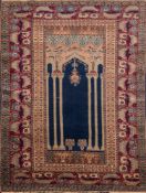 A Panderma rug:, the indigo architectural panel with a hanging lantern,