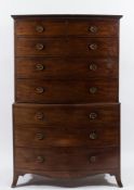 An early 19th Century mahogany and inlaid bow fronted tallboy:, bordered with ebonised lines,