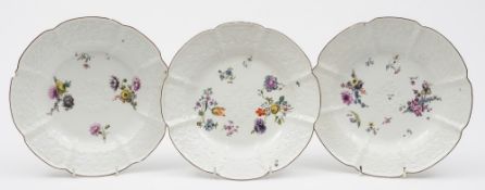 A set of three Meissen plates: each moulded in Gotzkowsky manner with flowers and foliage and