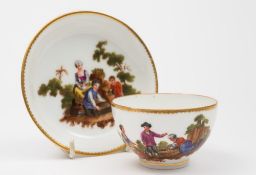 A Zurich cup and saucer: painted with landscape vignettes of rustic figures around a basket,