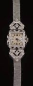 A lady's platinum, gold, diamond and black onyx cocktail wristwatch: the dial with Arabic numerals,