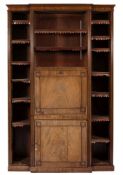 An early 19th Century mahogany breakfront bookcase/secretaire:, with reeded stiles,