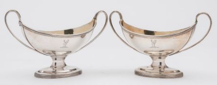 A pair of George III silver pedestal salts.