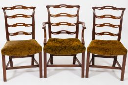 A set of six Georgian mahogany ladderback dining chairs:,