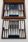 A set of twelve Victorian silver and mother of pearl handled dessert knives and forks,
