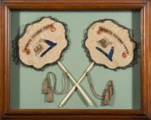 A pair of early 19th century silkwork and ivory handled face screens: the embroidered panels with