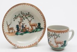 A Chinese export cup and saucer: painted with vignettes of deer around a tree,