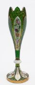 A Bohemian overlay glass vase: of slender footed form with knopped stem and castellated rim the