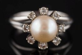 A cultured pearl and diamond circular cluster ring: the single cultured pearl approximately 7mm