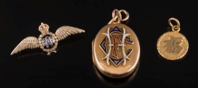 A gold and enamelled oval monogrammed locket,