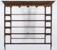 An 18th Century oak and pine plate rack:, with a moulded cornice,