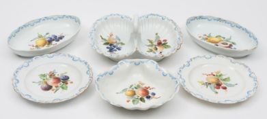 A Meissen porcelain dessert service: each piece enamelled with fruit and cut fruit within blue and