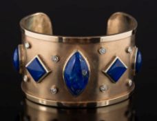 A diamond and lapis lazuli mounted cuff bangle: the wide band inset with round,
