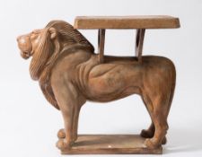 A terracotta plant stand:, modelled as a figure of an African lion supporting an oblong plateau,