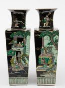 A pair of Chinese porcelain famille noire vases: of shouldered square form with raised flaring neck,