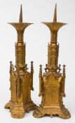 A pair of ormolu Gothic revival pricket candlesticks: with hexagonal flared sconces on arched