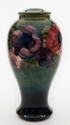 A Moorcroft pottery lamp base: of baluster form, tube lined in the Anemone pattern in red, blue,