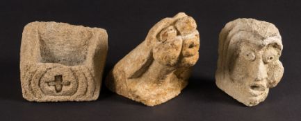 A group of three South West Church hamstone carvings: one in the form of a gargoyle,