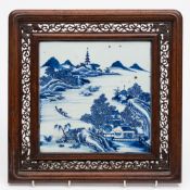 A Chinese blue and white porcelain and hardwood table screen: the square porcelain panel painted