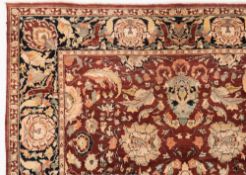 An Indo Persian carpet:, the brown field with an all over design of palmettes,