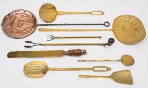 A group of various 18th and 19th century brass and copper skillets:, drainers, nips and spatula etc.
