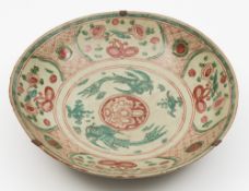 A large Chinese Swatow dish: of circular form enamelled in red and green with a pair of phoenix