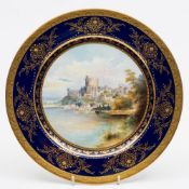 A Minton porcelain plate: of circular form enamelled by Arthur Holland with a view of Windsor