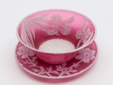 A late 19th century English cameo glass finger bowl and saucer: in ruby glass overlaid in white