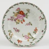 A Chelsea porcelain plate: of circular form with feather moulded rim enamelled in colours with