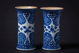 A pair of Chinese blue and white sleeve vases: painted with lotus blooms between bold ruyi-head and