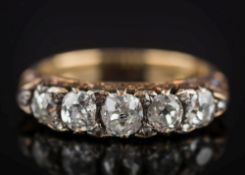 A late 19th century gold and diamond five-stone ring: with graduated round old brilliant-cut