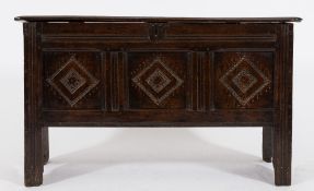 A 17th century oak rectangular coffer: of small size, with a plain hinged moulded top,