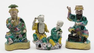 A Chinese famille rose group and two similar biscuit figures: the former modelled as the 'laughing