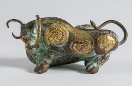 An Indian gilt decorated copper group of a lion attacking a bull: engraved and embossed with