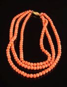 A graduated coral bead three-string necklace: with beads graduated from 6mm to 8.