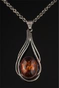 A modernist amber coloured, single stone pendant: with London import marks, on circular link chain.