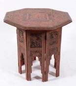 A Moorish red and black lacquer octagonal occasional table on a folding stand:,