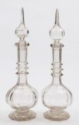 A pair of large mid 19th century Continental glass decanters and stoppers: of faceted decagonal