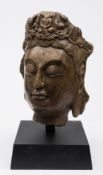 A large Chinese carved stone head of Guanyin: wearing elaborate jewelled headdress,
