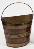 A 19th Century mahogany and brass bound elliptical swing handled bucket:,