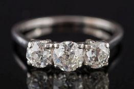 A diamond three-stone ring: with round, old-cut diamonds approximately 0.25ct, 0.50ct and 0.