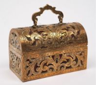 A pierced brass jewellery casket: with domed hinged lid having engraved foliate and pierced