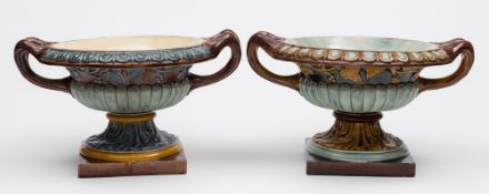 A close pair of Doulton Lambeth majolica urns: of squat campana form,