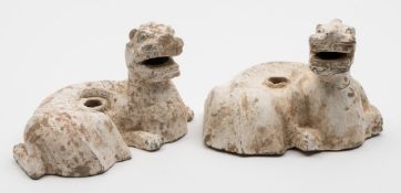 A pair of Chinese pottery money tree stands: in the form of reclining mythical beasts with open