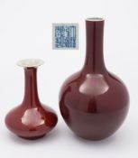 A Chinese sang de boeuf glazed vase and one other: the former of bottle shaped form with an evenly