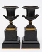 A pair of 19th century campana-shaped urns: with gilt decorated handles and knop,